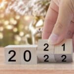 New year 2020 change to 2021. Hand flip over wooden cube block. New year holiday concept